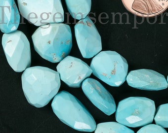 May include: A strand of turquoise gemstone beads, each bead is faceted and has a light blue colour. The beads are arranged in a loose pile, with a penny for scale.