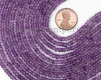 May include: A strand of amethyst gemstone beads, faceted and purple in color. The beads are approximately 4mm in size and are strung on a clear thread. A US penny is included for scale.