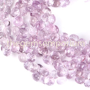 May include: A collection of faceted, light purple amethyst beads. The beads are strung together, displaying a variety of shapes and sizes. The text "thegemsemporium" is visible in the image.