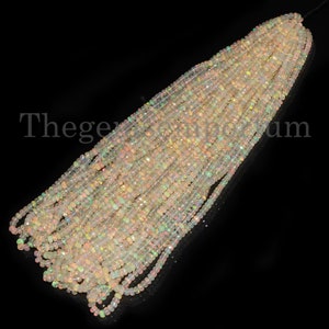 May include: A strand of white opal beads, with a slight iridescent sheen. The beads are faceted and have a square shape. The strand is approximately 16 inches long.