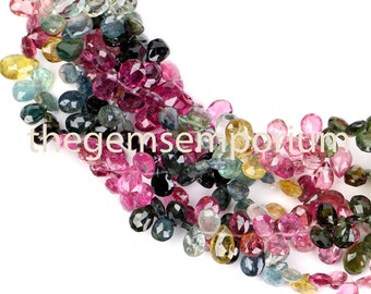 May include: A strand of multi-colored gemstone beads. The beads are faceted and have a teardrop shape. The colors of the beads include pink, green, blue, and yellow.