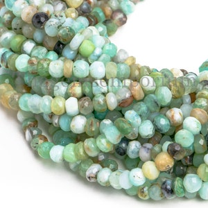 May include: A strand of green, blue, and brown faceted gemstone beads. The beads are small and round, and they have a natural, organic look.