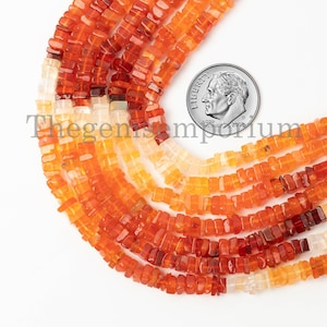 May include: A strand of orange, yellow, and white carnelian gemstone beads. The beads are square shaped and have a polished finish. The beads are approximately 6mm in size. The beads are strung on a clear elastic cord. The beads are shown next to a US dime for scale.