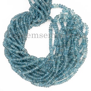 May include: A strand of light blue gemstone beads. The beads are faceted and have a slightly irregular shape. The beads are strung on a clear thread.