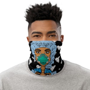 May include: A black face covering featuring a cartoon illustration of a healthcare worker in a blue surgical cap and a green face mask. White hearts are scattered on the black background. The person is wearing a grey shirt.