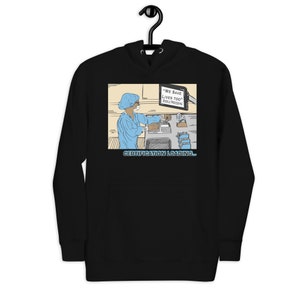 Könnte beinhalten: Schwarzer Kapuzenpullover mit einer Cartoon-Illustration eines medizinischen Fachangestellten in Arbeitskleidung. Das Bild enthält den Text "WE SAVE LIVES TOO" und "CERTIFICATION LOADING..."