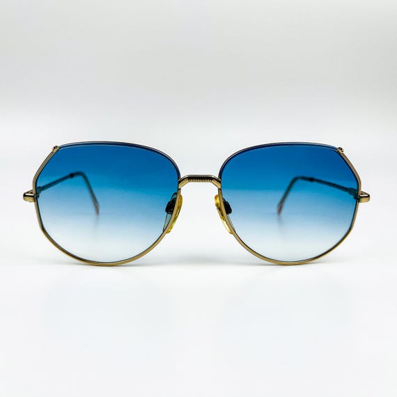 Gafas de sol vintage Luxottica: montura de metal dorado de los