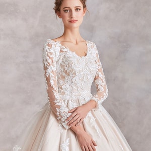 Stunning Champagne Peach Ball Gown Wedding Dress with French Lace, Bateau Neck, Long Sleeves & Pearl Button Back