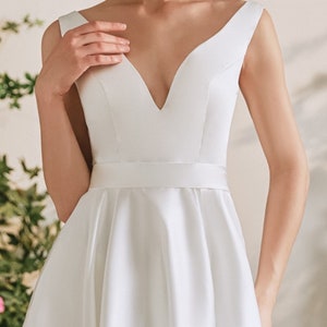 Simple Satin Luxury Wedding Dress with Pockets, Hi/Lo Skirt & Cutaway Back with Bow