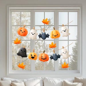 Könnte beinhalten: Halloween-Fensterdekoration mit Kürbissen, Geistern, Fledermäusen und orangefarbenen Blättern aus Filz. Die orangefarbenen Kürbisse haben lächelnde Gesichter. Die Geister sind weiß und die Fledermäuse sind dunkelblau. Die Dekorationen sind mit Schnur am Fenster befestigt.
