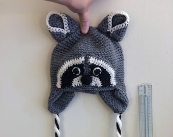 Crochet child raccoon hat with side tassles