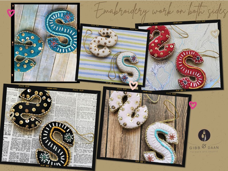 May include: Five embroidered felt letter S ornaments in different colors and patterns. The ornaments are decorated with sequins, beads, and embroidery. The text "Embroidery work on both sides" is visible in the image.