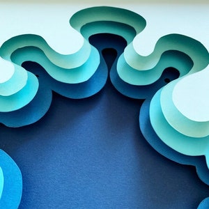 May include: Abstract paper art with layered, overlapping shapes in shades of blue and white. The shapes are cut out to create a 3D effect.