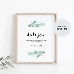Pode incluir: Um sinal imprimível com um design de folhas verdes em aquarela. O sinal diz "date jar" e "Compartilhe sua melhor ideia de encontro para o novo Sr. e Sra."