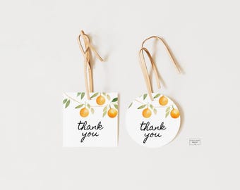 Può includere: Due etichette regalo di ringraziamento con un'illustrazione ad acquerello di rami di aranci con foglie e frutti. Le etichette sono bianche con testo nero che dice "grazie".