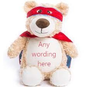 May include: A beige teddy bear dressed as a superhero, featuring a red mask and cape. The bear has the text "Any wording here" on its white belly. The bear has a brown nose and is made of soft plush material.