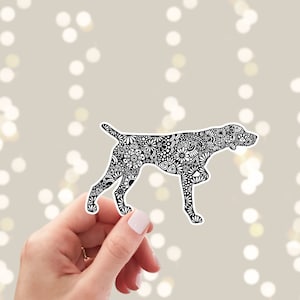 May include: Black and white sticker of a German Shorthaired Pointer dog with a detailed floral pattern. The dog is in a standing position with its head turned to the side.