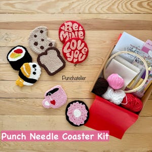 May include: A punch needle coaster kit featuring food and Valentine's Day designs. The kit includes coasters shaped like sushi, a cookie, toast, a coffee cup, a donut, and coasters with the words "Be Mine" and "Love You". The kit also includes yarn and a wooden embroidery hoop.