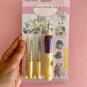 May include: A yellow and purple punch needle set with three different sized needles. The packaging shows examples of different stitches that can be created with the punch needle. The packaging also includes the text "Punch Needle Set" and "Quality Product".