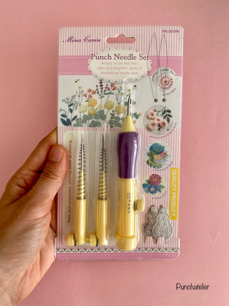 May include: A yellow and purple punch needle set with three different sized needles. The packaging shows examples of different stitches that can be created with the punch needle. The packaging also includes the text "Punch Needle Set" and "Quality Product".
