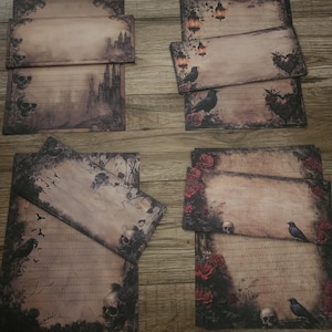 May include: A collection of gothic-themed stationery featuring illustrations of castles, ravens, skulls, and roses. The stationery has a vintage, aged appearance with lined paper for writing. The color palette includes shades of brown, black, and red.