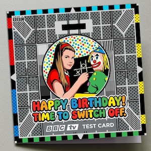 May include: A square greeting card featuring a BBC test card pattern with a central circular illustration of a girl playing tic-tac-toe with a clown puppet. The text reads HAPPY BIRTHDAY! TIME TO SWITCH OFF. BBC TV TEST CARD in white letters.