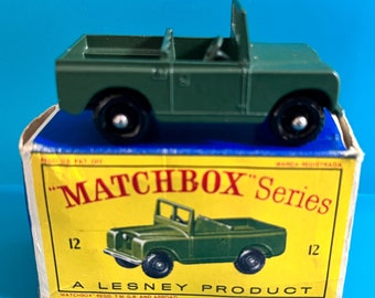 May include: Green Matchbox Series 12 die-cast toy car model of a Land Rover. The car is in its original box, which has the words "Matchbox Series" printed on it.