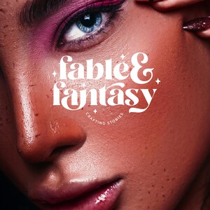 May include: A close-up of a woman's face with pink eyeshadow and a bold graphic design for a brand called "Fable & Fantasy: Crafting Stories".