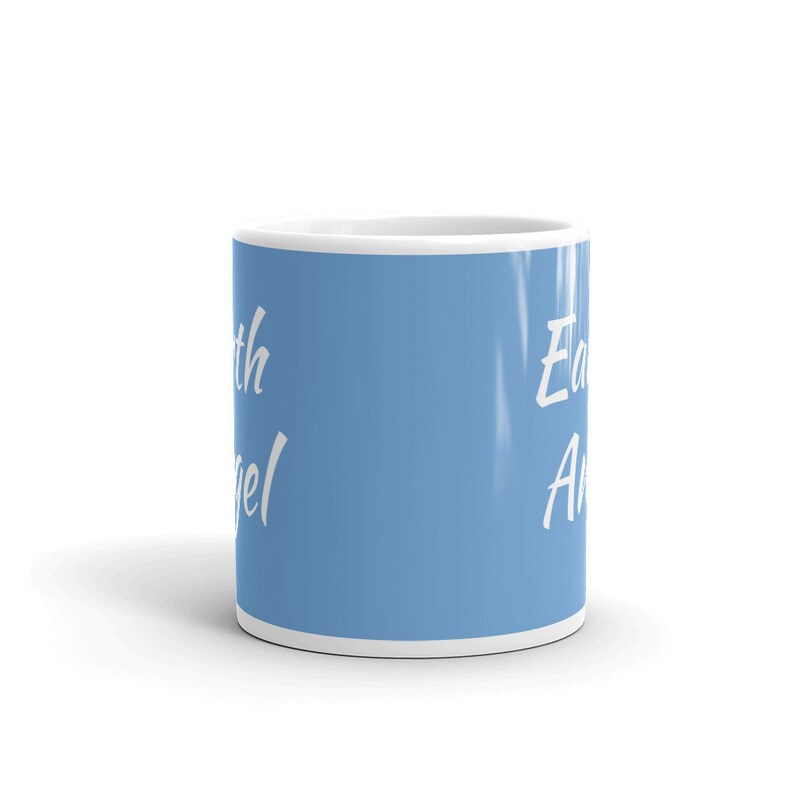 May include: A light blue ceramic mug with white text that reads "Earth Angel".