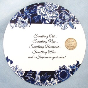 May include: A white card with blue floral border and the text "Something Old... Something New... Something Borrowed... Something Blue... and a Sixpence in your shoe!" with a gold coin in the upper right corner.