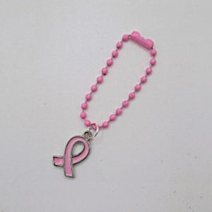 May include: Pink beaded keychain with a pink ribbon charm. The ribbon is a symbol of breast cancer awareness.