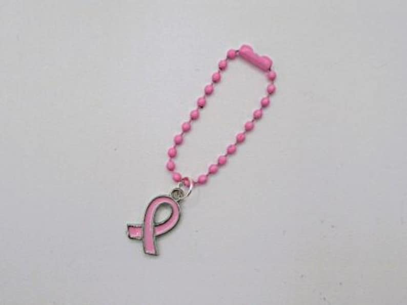 May include: Pink beaded keychain with a pink ribbon charm. The ribbon is a symbol of breast cancer awareness.