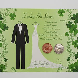 May include: A light green wedding card with the text "Lucky In Love" and a wedding rhyme. The card features illustrations of a tuxedo, a wedding dress, and two coins. Green shamrocks decorate the border.
