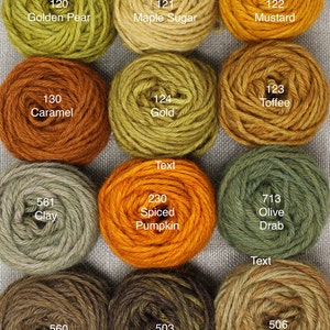 May include: A collection of 12 skeins of yarn in various shades of brown, green, yellow, and orange. The yarn is labeled with numbers and names such as "Golden Pear", "Maple Sugar", "Mustard", "Caramel", "Gold", "Toffee", "Clay", "Spiced Pumpkin", "Olive Drab", "Chestnut", "Brown", and "Tan".