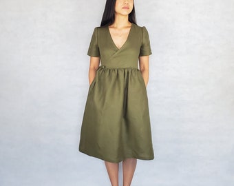Wrap dress with a below-the-knee ruffled skirt, short sleeves, and pockets