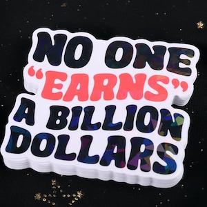 May include: A white sticker with the text "NO ONE 'EARNS' A BILLION DOLLARS" in a bold, colorful font. The words are stacked on top of each other. The sticker has a holographic effect.