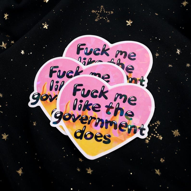A flaming heart-shaped sticker with the text "Fuck me like the government does"