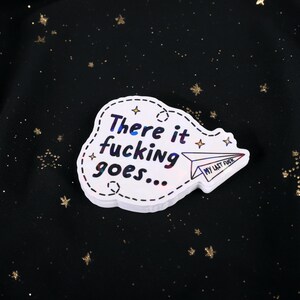 A sticker with the phrase "There it fucking goes..." and a small paper airplane graphic flying away that says "My Last Fuck"