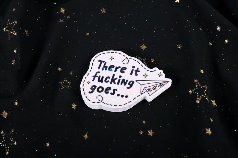 A sticker with the phrase "There it fucking goes..." and a small paper airplane graphic flying away that says "My Last Fuck"