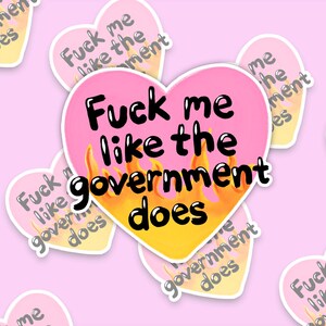 A flaming heart-shaped sticker with the text "Fuck me like the government does"
