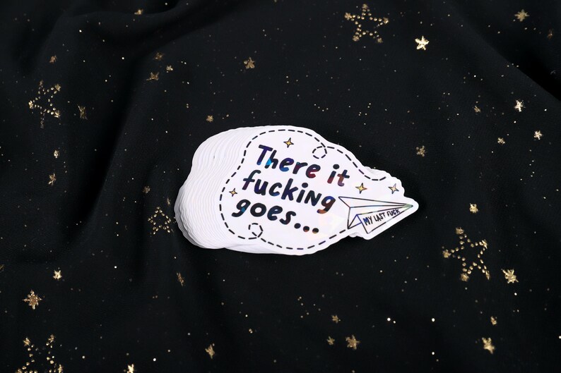 A sticker with the phrase "There it fucking goes..." and a small paper airplane graphic flying away that says "My Last Fuck"