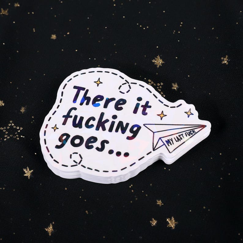 A sticker with the phrase "There it fucking goes..." and a small paper airplane graphic flying away that says "My Last Fuck"