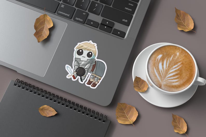 A mockup of a holographic sticker Of Laios Touden  of Dungeon Meshi / Delicious in dungeon imagined as the yippee / Autism Creature on the laptop.
