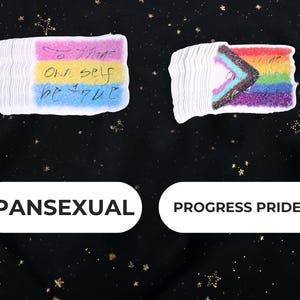 A Holographic Sticker of the Shakespeare quote from Hamlet "To Thine Own Self Be True" on the pan and Progress Pride FLags