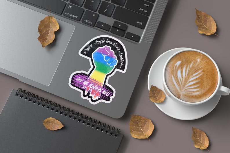Queer People have always existed, and always will, Broken Glass Style Holographic 3 inch sticker, rainbow colored power fist mockup, On a Laptop