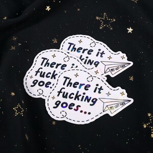 A sticker with the phrase "There it fucking goes..." and a small paper airplane graphic flying away that says "My Last Fuck"