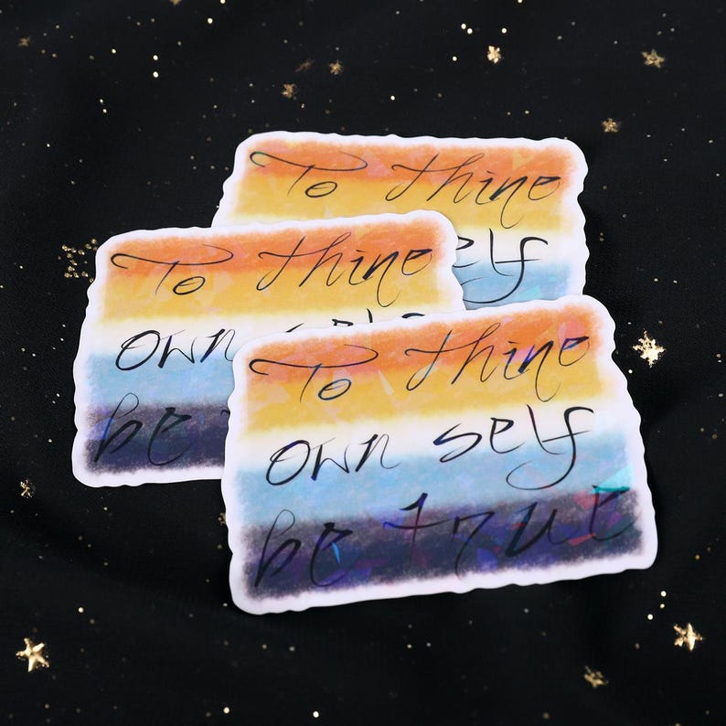 A Holographic Sticker of the Shakespeare quote from Hamlet "To Thine Own Self Be True" on the AroAce flag.