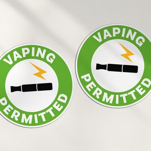 May include: Two green and white round stickers with the text "Vaping Permitted" and a black and white image of a vape pen with a yellow lightning bolt.