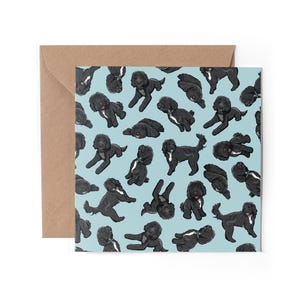 May include: A blue card with a repeating pattern of black doodle dogs. The dogs are in various poses, including sitting, standing, and lying down.