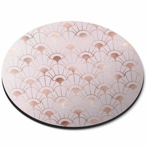 May include: Round pink and rose gold mouse mat with a geometric pattern of overlapping fan shapes.